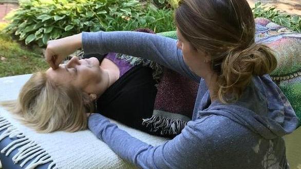 Practitioner holding points on client's head